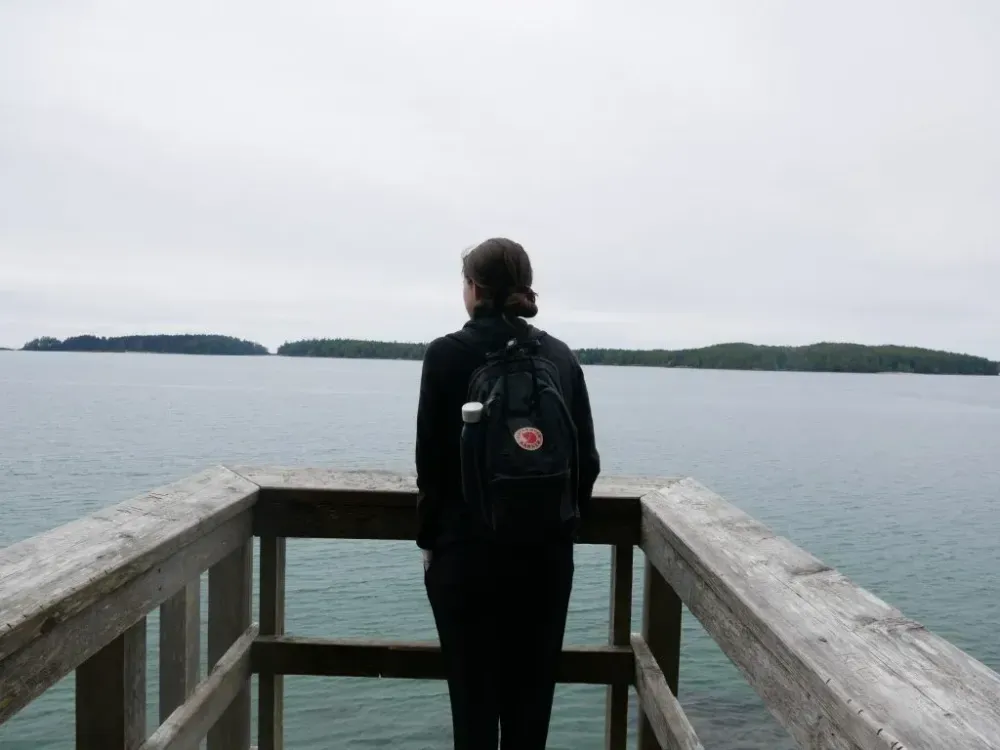 person hiking enjoying ocean view